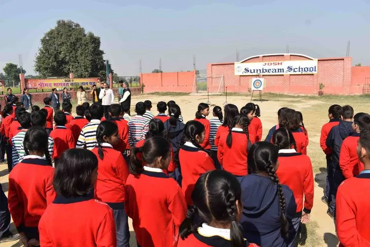 The archery target set up on the ground at Sunbeam School Ballia, classes gathered around it.