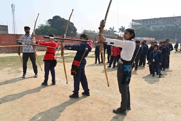A student of Sunbeam School Ballia drawing a recurve bow on the archery line.