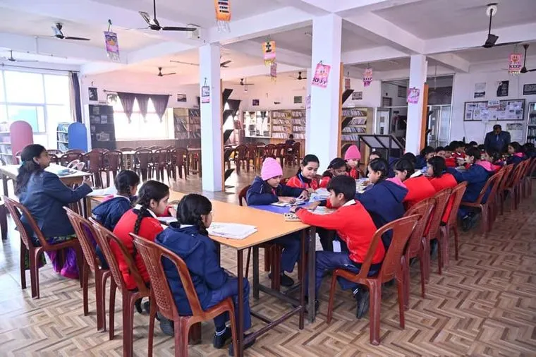 Students reading at tables in the Nalanda Library at Sunbeam School Ballia.